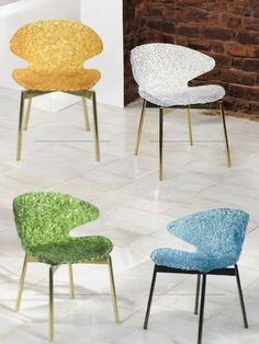 four different colored chairs sitting next to each other