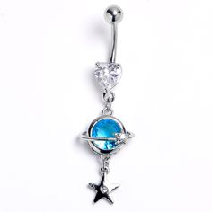 Product DetailsClear Blue Gem Heart Saturn Star Dangle Belly Ring This 14 gauge navel ring is out of this world. It is made with a 3/8 inch 316L surgical grade stainless steel curved barbell with a 5mm top ball end. The bottom end is a clear gem with a heart shape. Dangling beneath is the planet Saturn, with the planet composed of a single blue gem and ring. Beneath the planet dangles a small star charm, set with a clear gem for an added touch of style. This heavenly body is sure to make your be Belly Piercing Jewelry, Planet Saturn, Belly Piercing Ring, Navel Jewelry, Dangle Belly Rings, Navel Ring, Piercing Ring, Belly Piercing, Belly Button Piercing