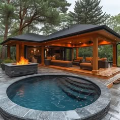 a hot tub sitting in the middle of a patio next to a fire pit