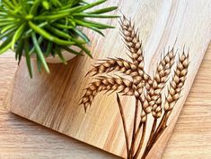 a wooden cutting board with some plants on it