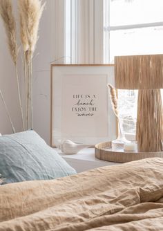 a bedroom with a bed, two lamps and a framed print that says life is a journey enjoy the journey