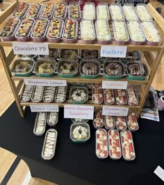 there are many trays of food on the display shelf at the store that is selling them