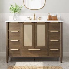 a bathroom vanity with two sinks and a large mirror above it, along with a rug on the floor