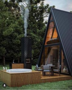 a - frame cabin with an outdoor hot tub