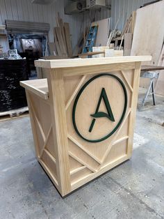 a wooden box with the letter a on it in front of other woodworking tools