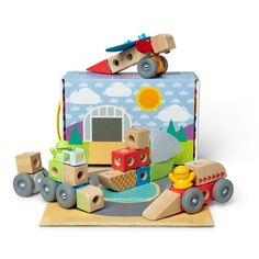 a wooden toy train set sitting on top of a white table next to a blue suitcase