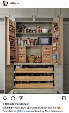 an open pantry with lots of drawers and food items in the cupboards next to it