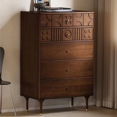 a wooden dresser sitting next to a window