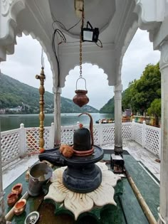 a tea kettle is sitting on top of a table in the middle of a gazebo