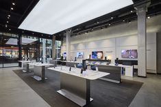 an empty store with tables and chairs in the middle of it's display area