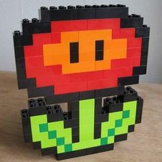 an image of a toy made out of legos on a wooden table with one eye open