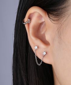 Enhance your look with our shining star chain earrings! These stunning earrings require two ear piercings for a charming and unique style. Add a touch of glamour to any outfit and make a bold statement with these must-have accessories. Detail： -Post material: gold plated with internal stainless steel or stainless steel. Cubic Zirconia -Gauge: 20g | 0.8mm-Post length: 6mm-Star dimensions: 4mm Length x 4.2mm Width -Chain length: 34mm-Include: single item -Closure: screw ball back * Shop extra ball Ear Piercing Studs, Ear Chain, Ear Style, Titanium Earrings, Star Chain, Daily Jewelry, Jewelry Lookbook, Shining Star, Stunning Earrings