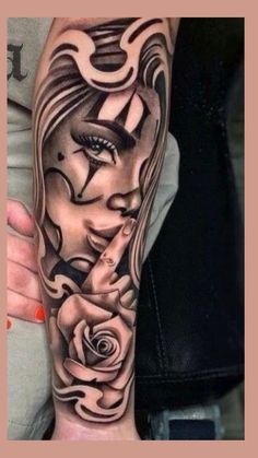 a woman's arm with tattoos on it and roses in the middle of her hand