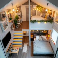 an aerial view of a bedroom and living room in a tiny house with stairs leading to the second floor