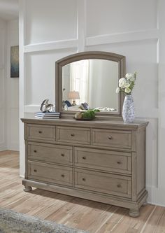 a dresser with a mirror on top of it