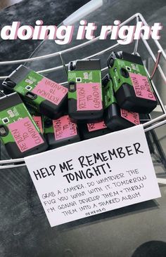 a bunch of pink and green tags are on a wire with a sign that says help me remember tonight