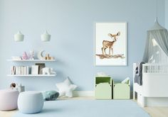 a baby's room with blue walls and white furniture