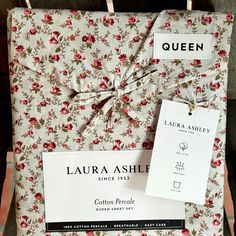 the packaging is wrapped in floral fabric and tied with twine string, which also has tags attached to it