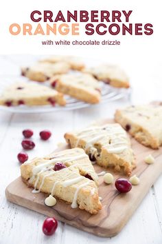 cranberry orange scones with white chocolate drizzle on a cutting board