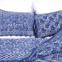 a blue and white bed with two pillows