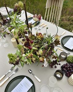 the table is set with flowers and place settings