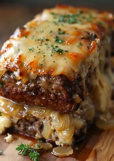 a wooden cutting board topped with lasagna covered in cheese and meat sauce, garnished with parsley