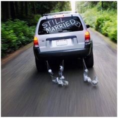 a car driving down the road with two legs attached to it's back end