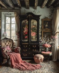 an old fashioned bedroom with floral wallpaper and antique furniture, including a large armoire