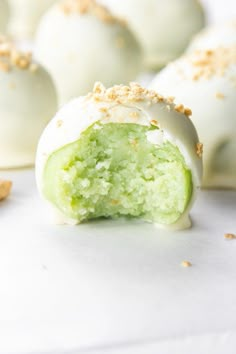 some white chocolate balls with green frosting and sprinkles