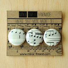 three buttons with musical notes on them