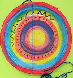 a paper plate that has been made to look like a colorful circle with lines and shapes on it