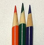 four colored pencils lined up in a row