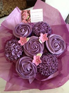 purple cupcakes are arranged in a bouquet