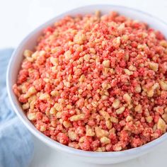 a white bowl filled with red food on top of a table