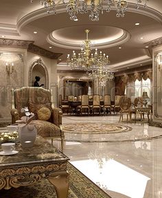 a fancy living room with chandelier, chairs and tables in the middle of it