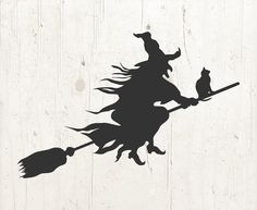 a black silhouette of a witch on a broom with a cat sitting on it's back