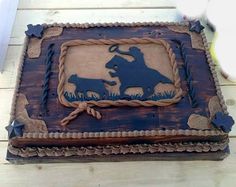 a cake that is sitting on top of a wooden table and decorated with an image of two dogs