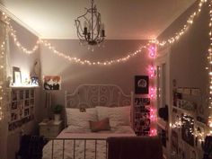 a bedroom with lights strung from the ceiling