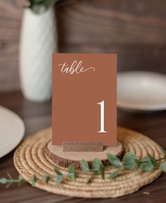 a table number is placed on top of a place card holder