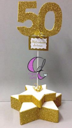 a cake topper that is shaped like a star with the number 50 on it