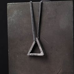 Triangle Pendant Necklace When pointing up, a triangle symbolizes stability, direction and power. In spirituality, triangles represent the union of body, mind, and spirit. This triangle pendant is a rustic piece of design made of 100% sterling silver. Size and Fit: The pendant's size: 20 mm x 20 mm You can choose to purchase only the pendant or add an oxidized sterling silver chain to it. The chain is 1.8 mm wide. My designs express the beauty of things imperfect, impermanent, and incomplete. I Masculine Jewelry, Georgetown Tx, Skull Pendant Necklace, Mens Necklace, Silver Jewelry Necklace, Triangle Pendant, Skull Pendant, The Union, Men's Necklace