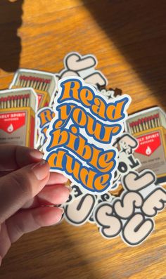 someone holding up a sticker that says read your stuff