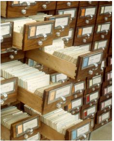 many files are stacked on top of each other in this room filled with wooden file cabinets