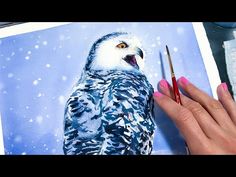 an owl is being painted on a piece of paper