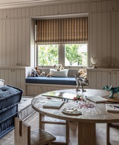 a living room filled with furniture next to a window covered in windowsills and curtains