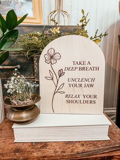 a wooden plaque that says take a deep breath and punch your law relax your shoulders