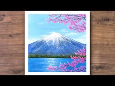 a painting of a mountain with pink flowers in the foreground and blue water below