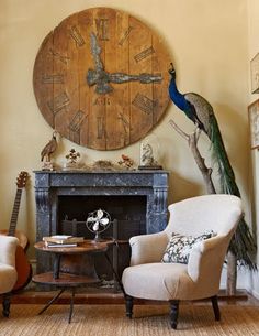 a living room filled with furniture and a large clock on the wall above it's fireplace