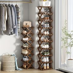 a wooden shelf with shoes on it in front of a window and clothes hanging on the wall