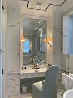 a bathroom with a vanity, chair and mirror